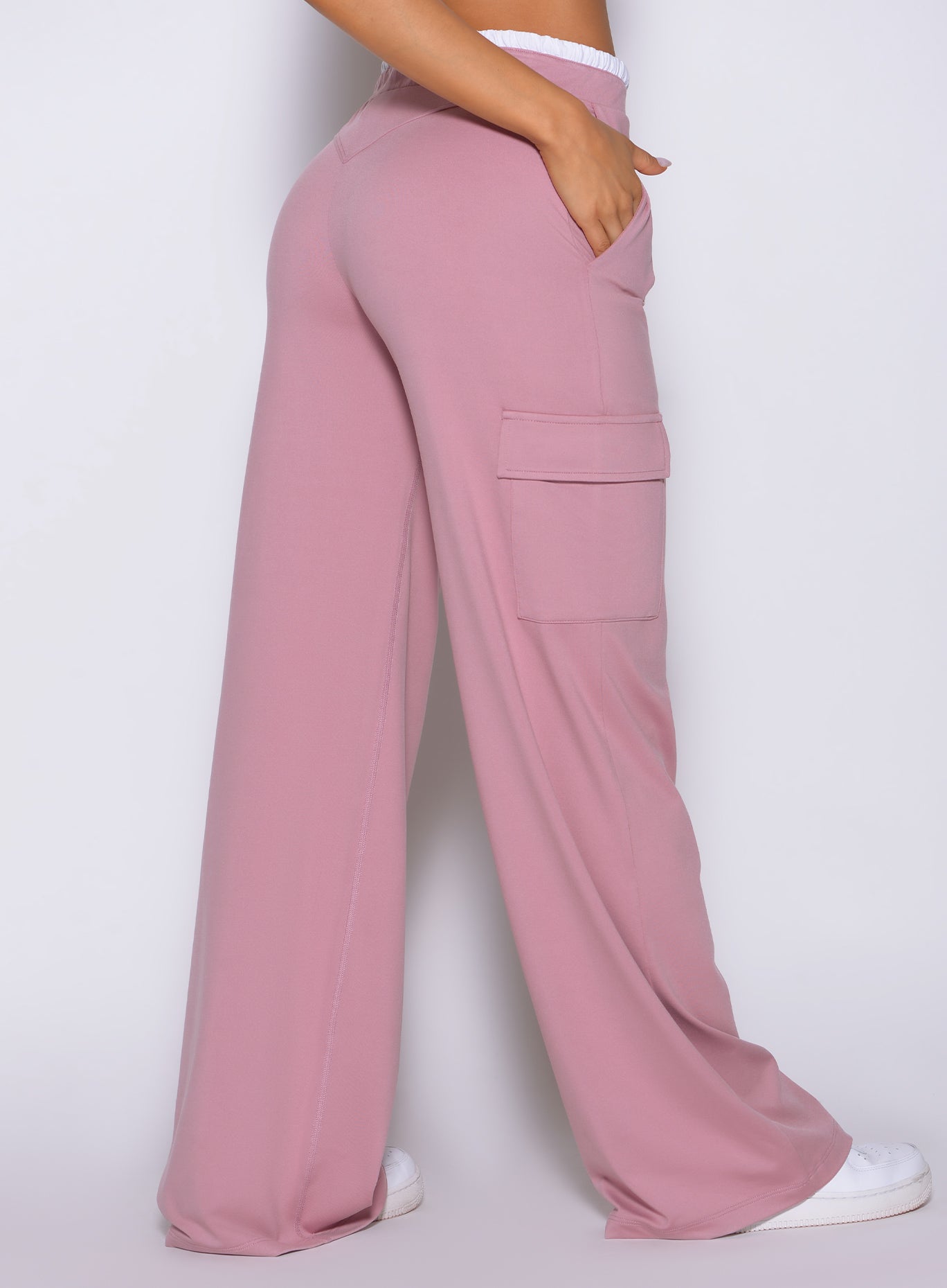 Rear close-up view of model wearing Bombshell Sportswear wide leg joggers in Cosmetic Pink color, highlighting relaxed fit and smooth lightweight fabric