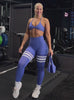 A short video of a model working out wearing our scrunch thigh-highs in violet blue with three white stripes on the thighs, complemented by a matching sports bra.
