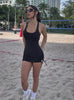 A short video of a model on a beach wearing the PowerFit Dress in black color