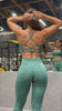Video of woman working out in a gym wearing a green cheetah print outfit