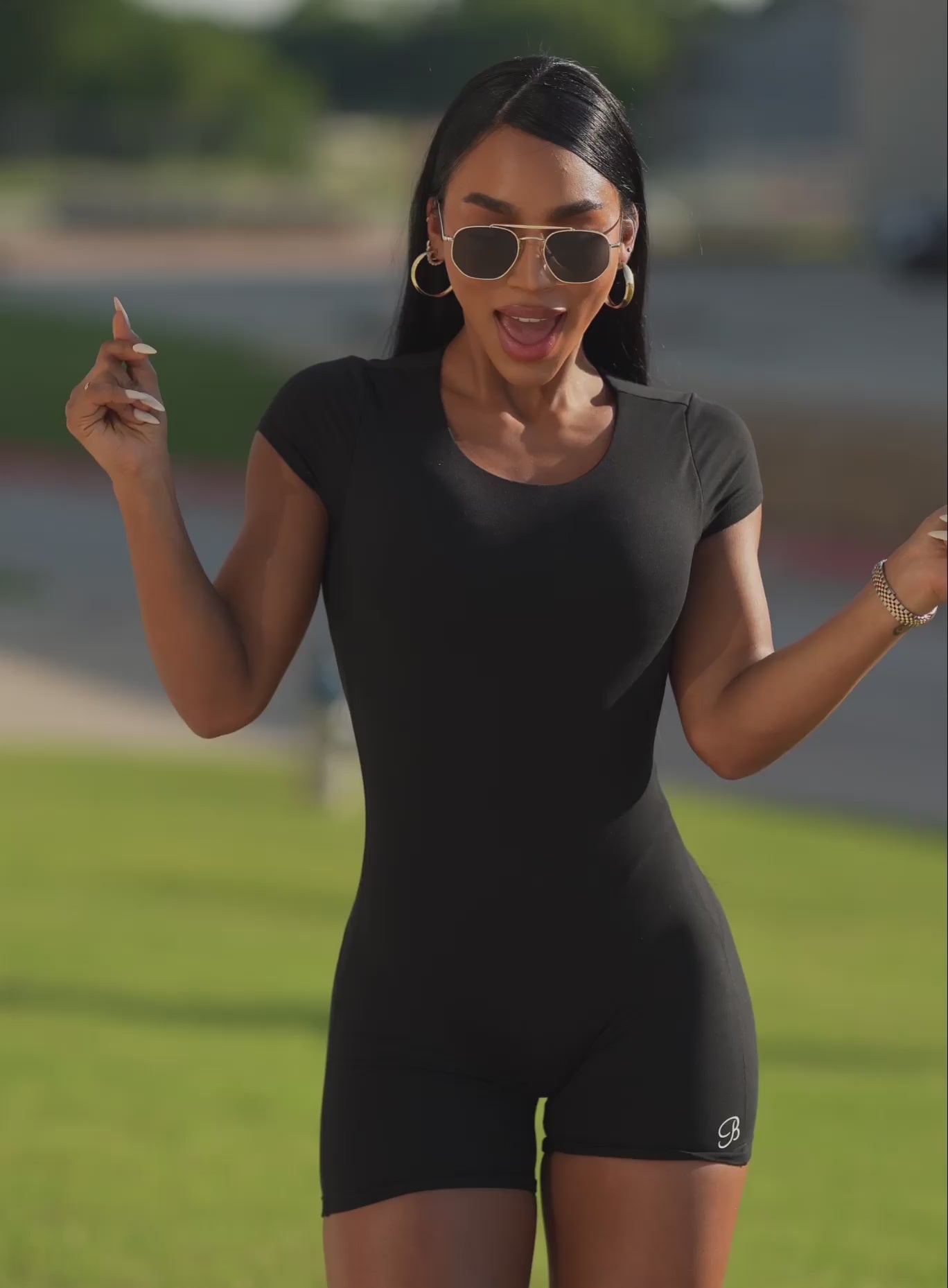 Black Open Back Tee Bodysuit Short with cap sleeves and a sculpting, compressive gym fit.