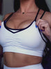 Model in white athletic shorts with matching bra.