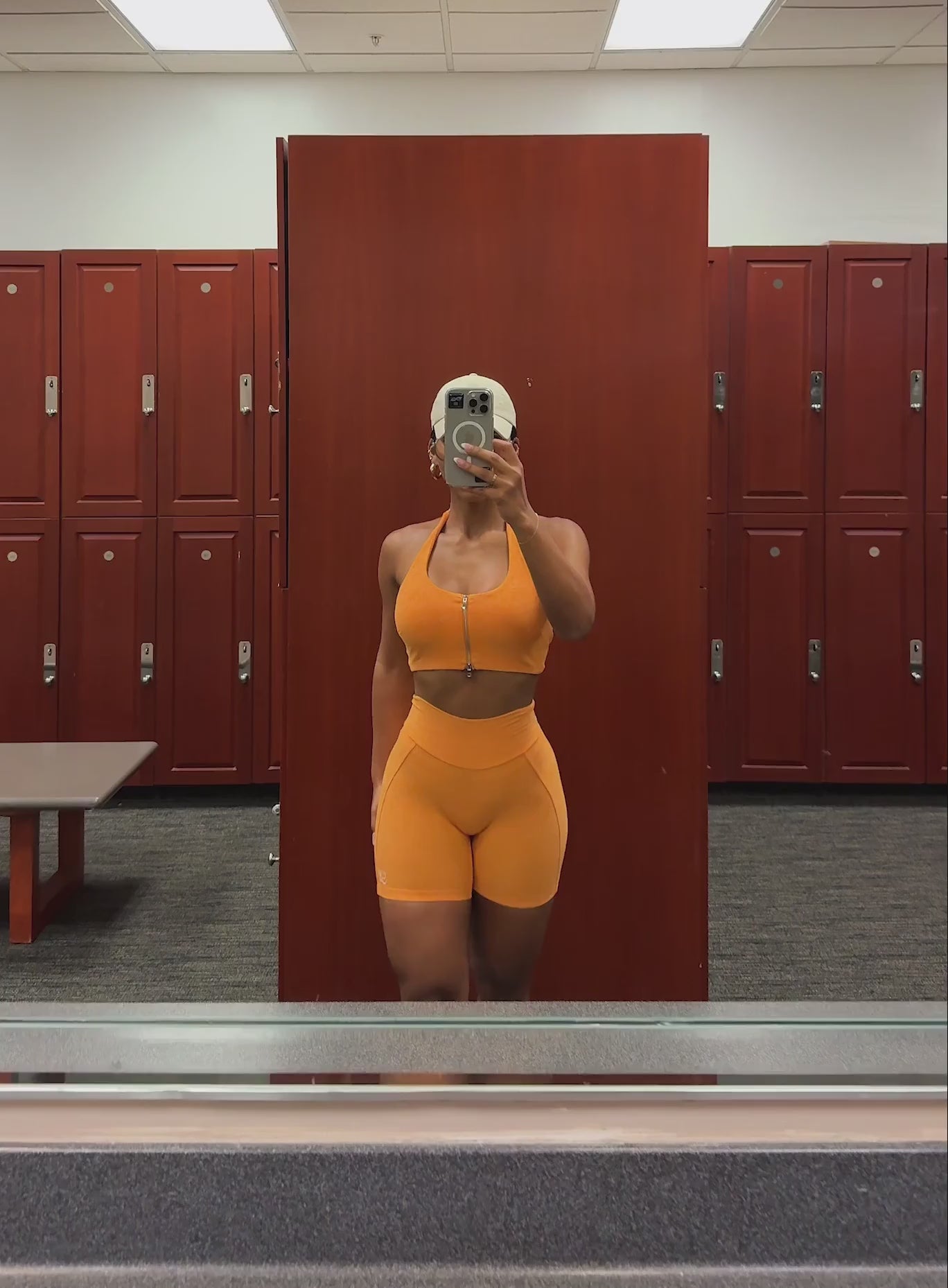 A short video showcase of a model wearing the Voltage sports bra in Kumquat color paired with the matching  shorts 