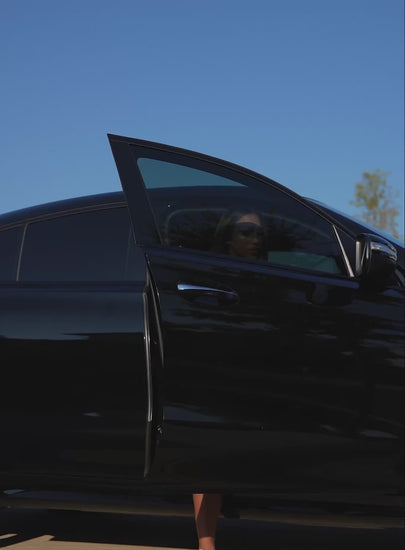 A short video of a model coming out of a car wearing the PowerFit Dress in blue slate color