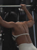 A short video showcase of a model working out in a gym wearing the Uplift Peach Shorts in Pearl white color paired with the matching bra