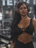 Video of a fit model wearing a black keyhole detailed sports bra and matching biker shorts.