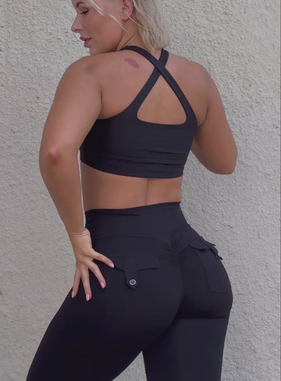 A short video of a model wearing our two way bra along with the a black pocket leggings 