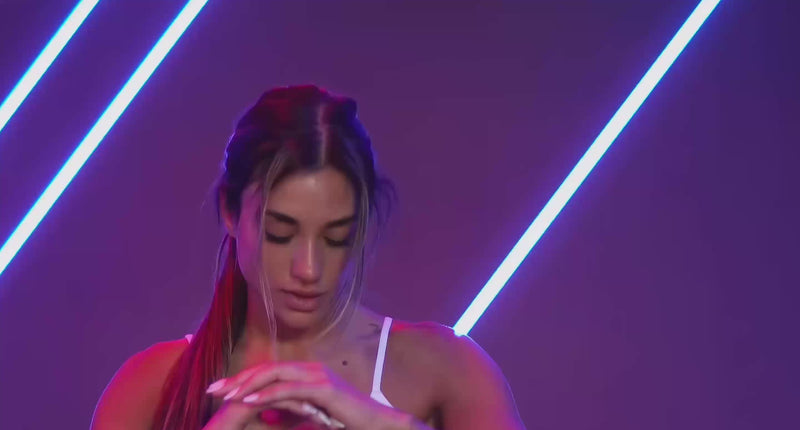 Video featuring an athletic model performing different types of high intensive workouts, wearing a pair of scrunch thigh-highs and a cinch cami tank.