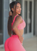 A short video of a model in outdoors showcasing the Curvemax shorts and leggings in Neon apricot pink 