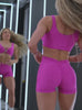 A short video showcase of a model in working out wearing the Curvemax Shorts in Neon pink sorbet color  paired with the matching bra