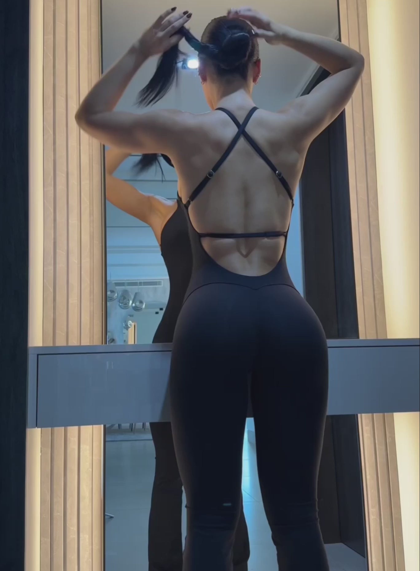 Black Bombshell Bunny Bodysuit with flared legs and high neck for a versatile gym-to-street look.