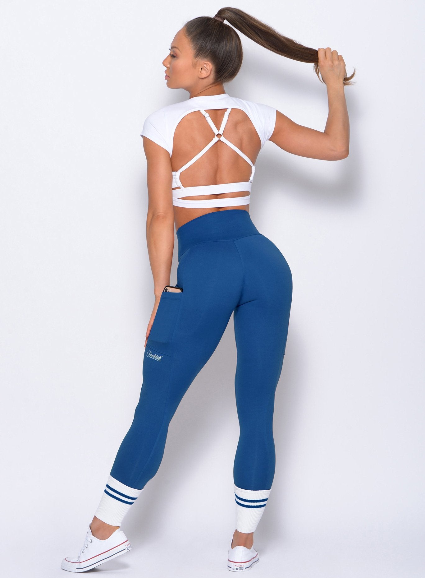 Back view of the model wearing the Ankle Sock Leggings in blue with blue stripes 