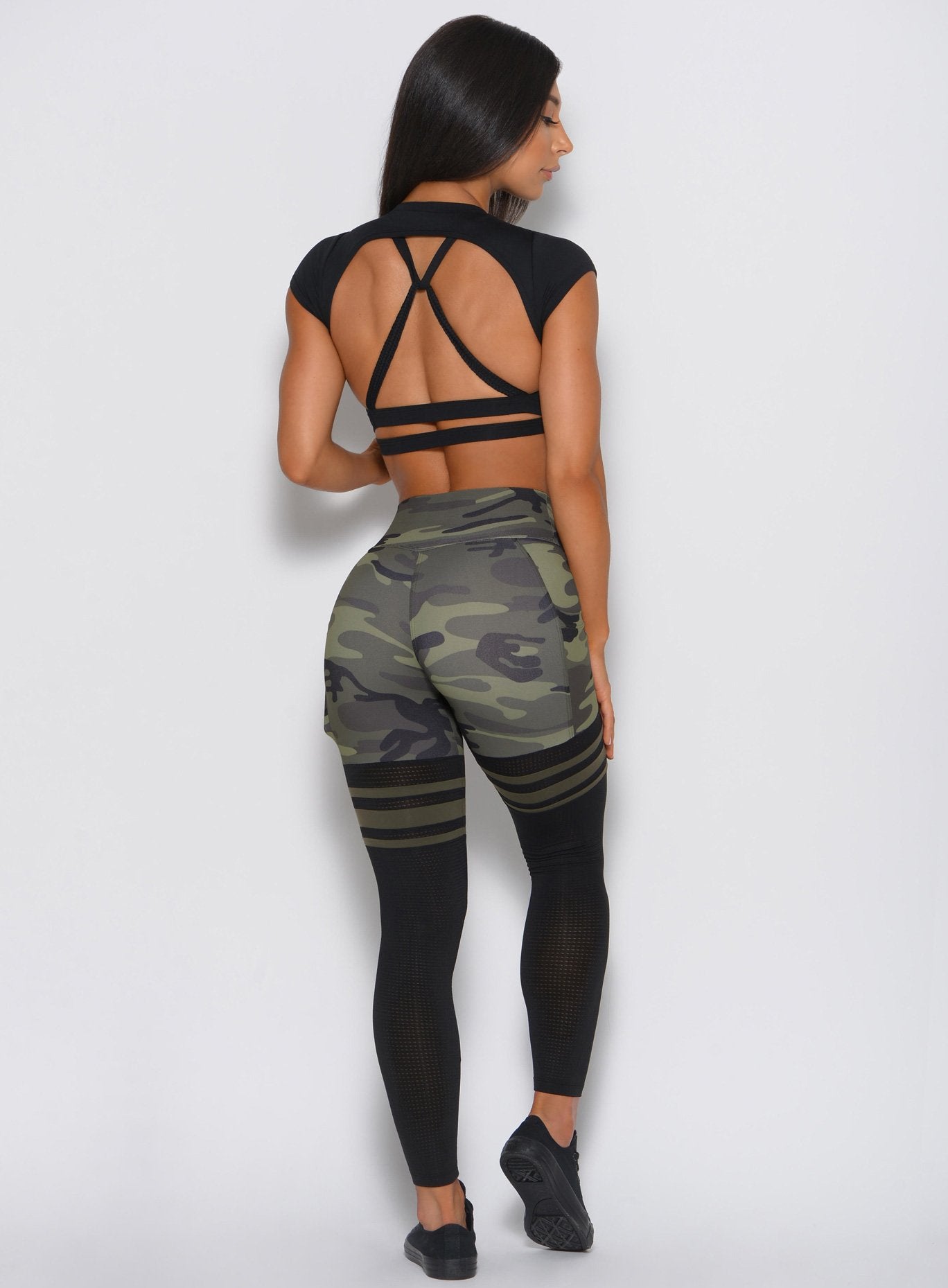 Open-back black Muscle Back Tee paired with camo leggings for a focused, high-performance gym look.