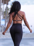 Back profile picture of a model wearing out black barbell bra and a matching leggings 