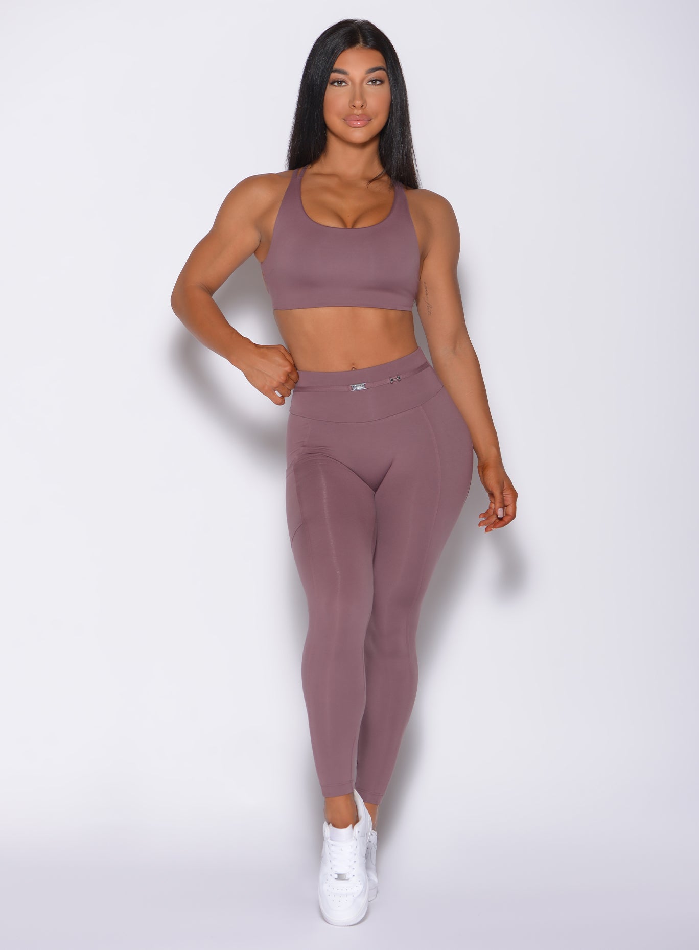 Front profile view of a model in our barbell legging in mauve color and a matching bra 
