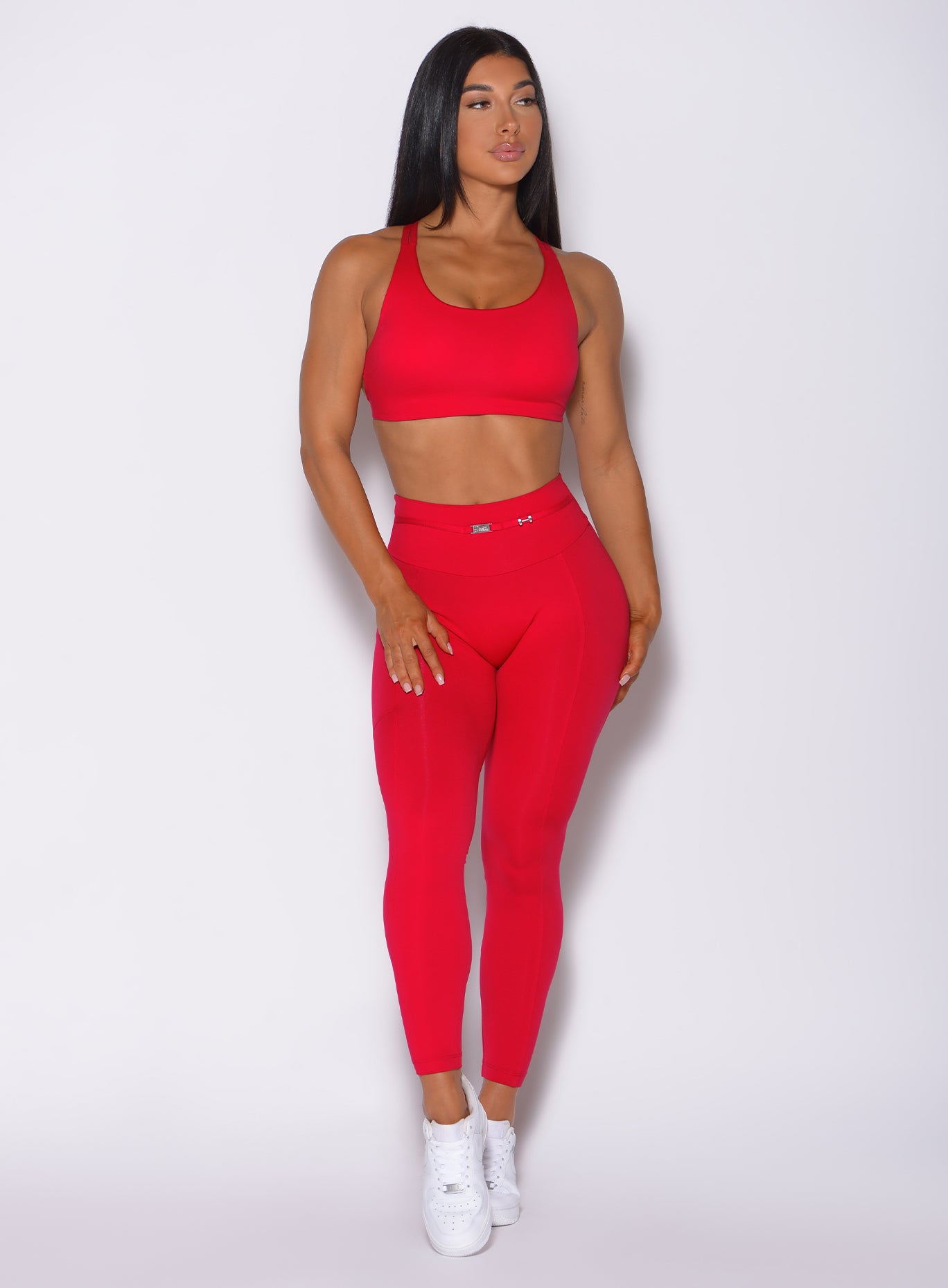 Front profile view of a model in our red barbell leggings and a matching bra 