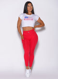 Front profile view of a model in our red barbell leggings and a white tee