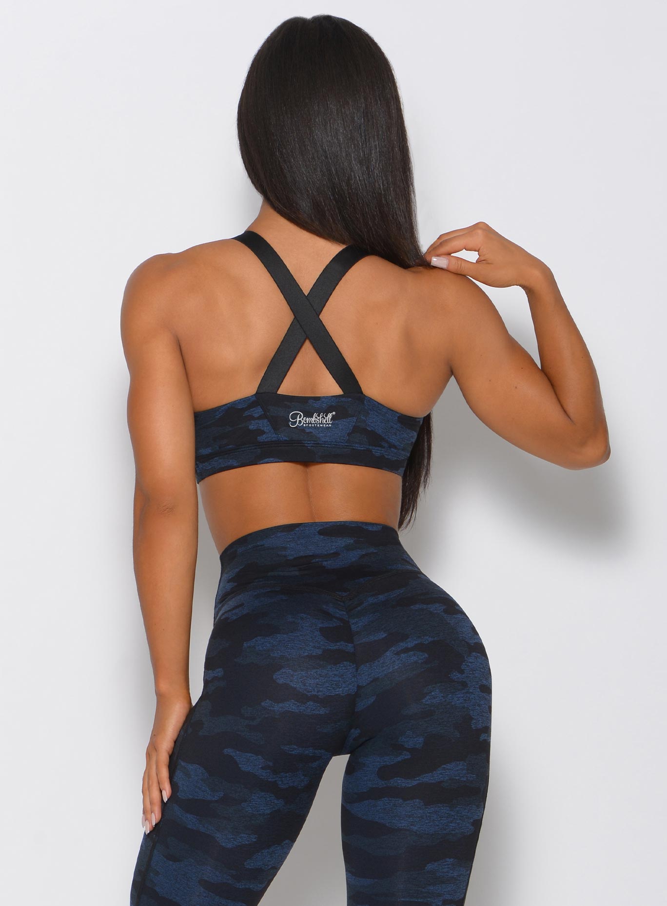 Back view of the model in the blue black camo sports bra 