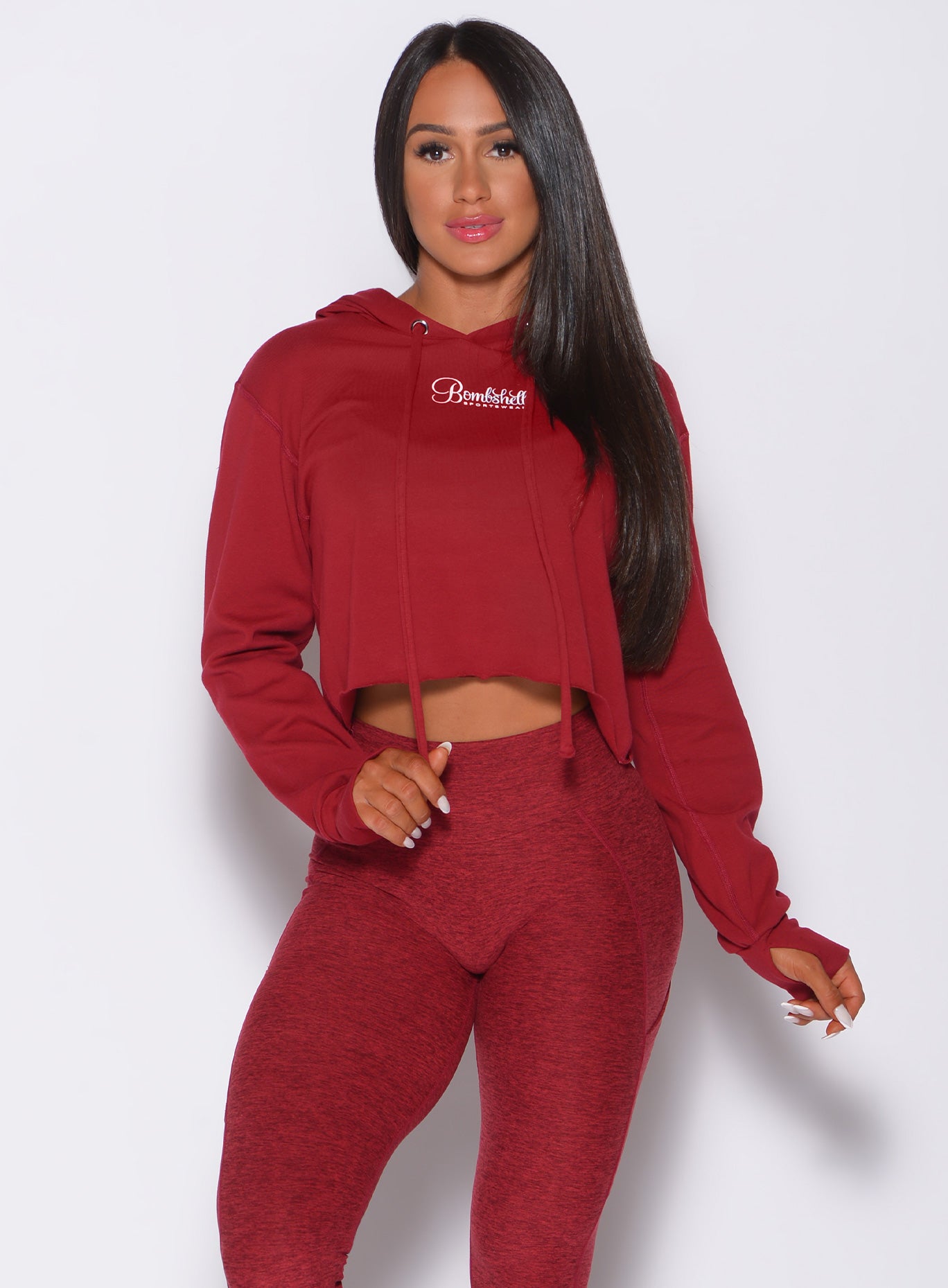 Model facing forward wearing our bombshell hoodie in red rose color and a matching leggings