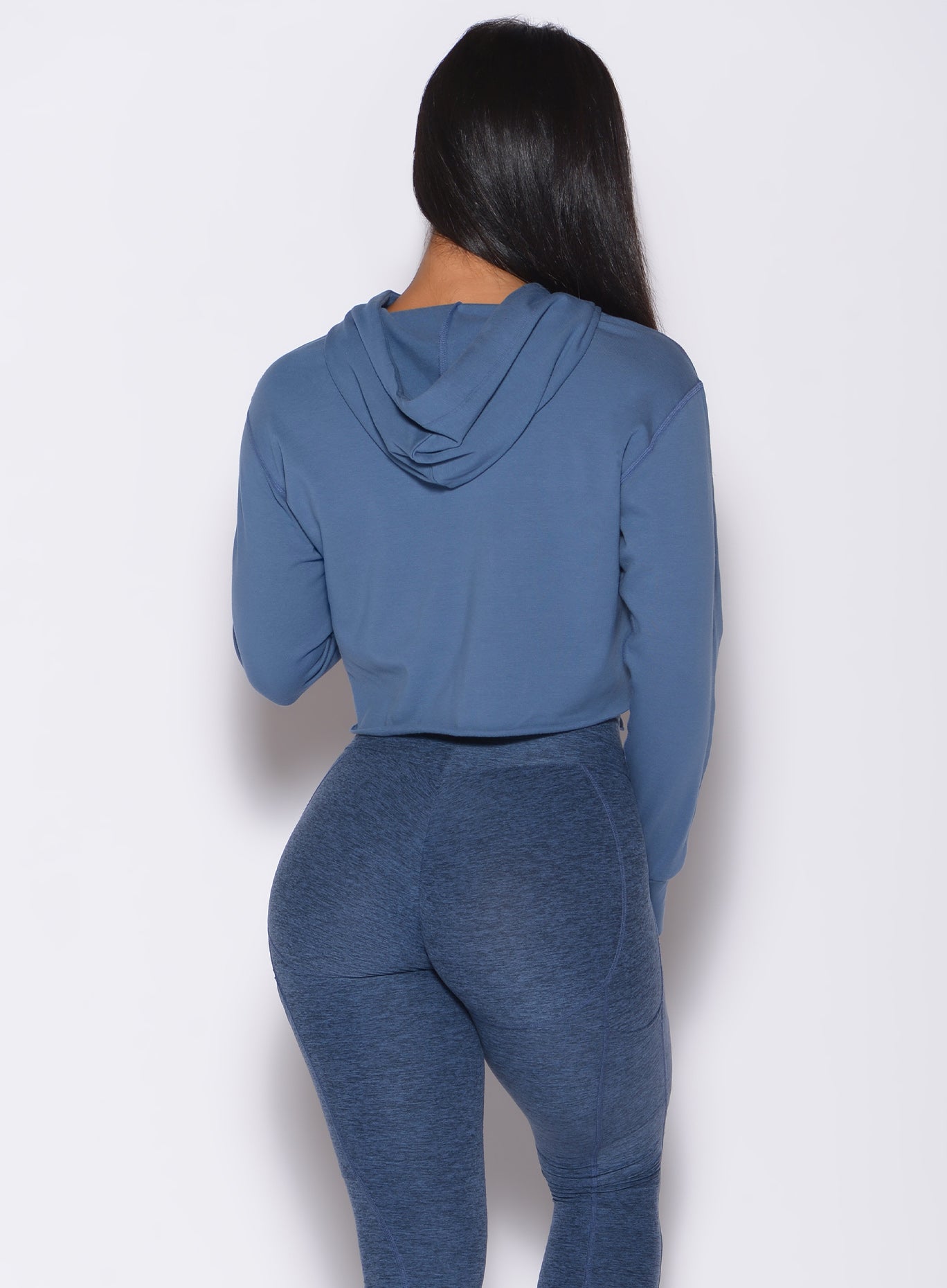 back  profile view of a model in our bombshell hoodie in blue star color and a matching leggings