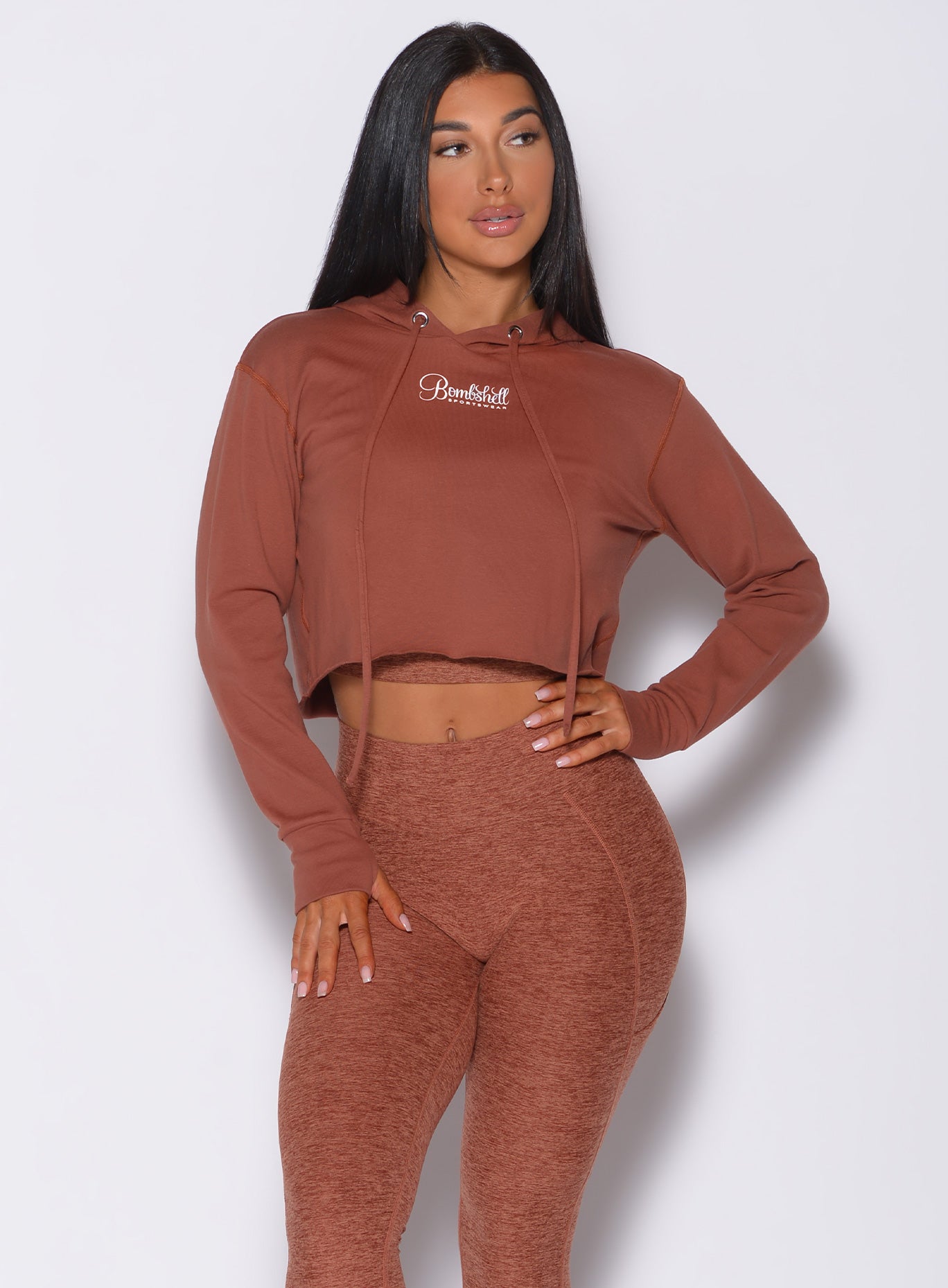 Front profile view of a model in our bombshell hoodie in caramel color and a matching leggings 