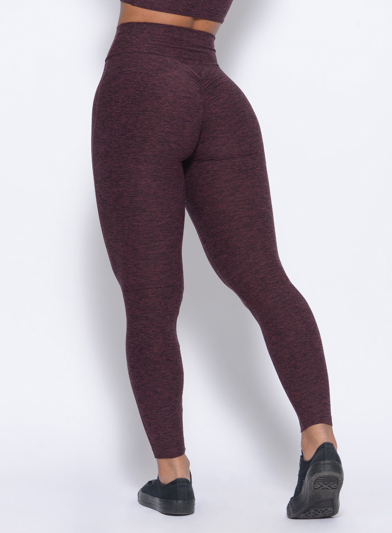 Zoomed in back view of our boost leggings in port color
