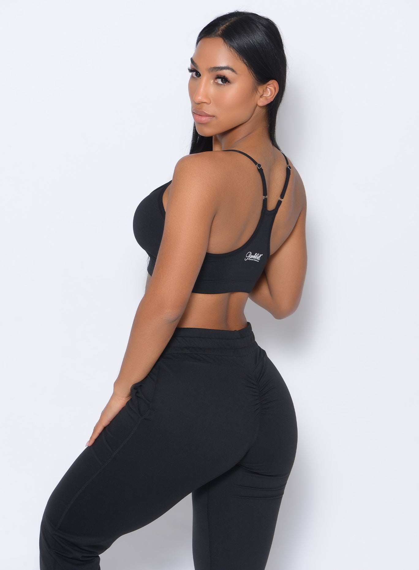 Left side view of the model  facing to her left wearing our Relax Sports Bra and a matching joggers