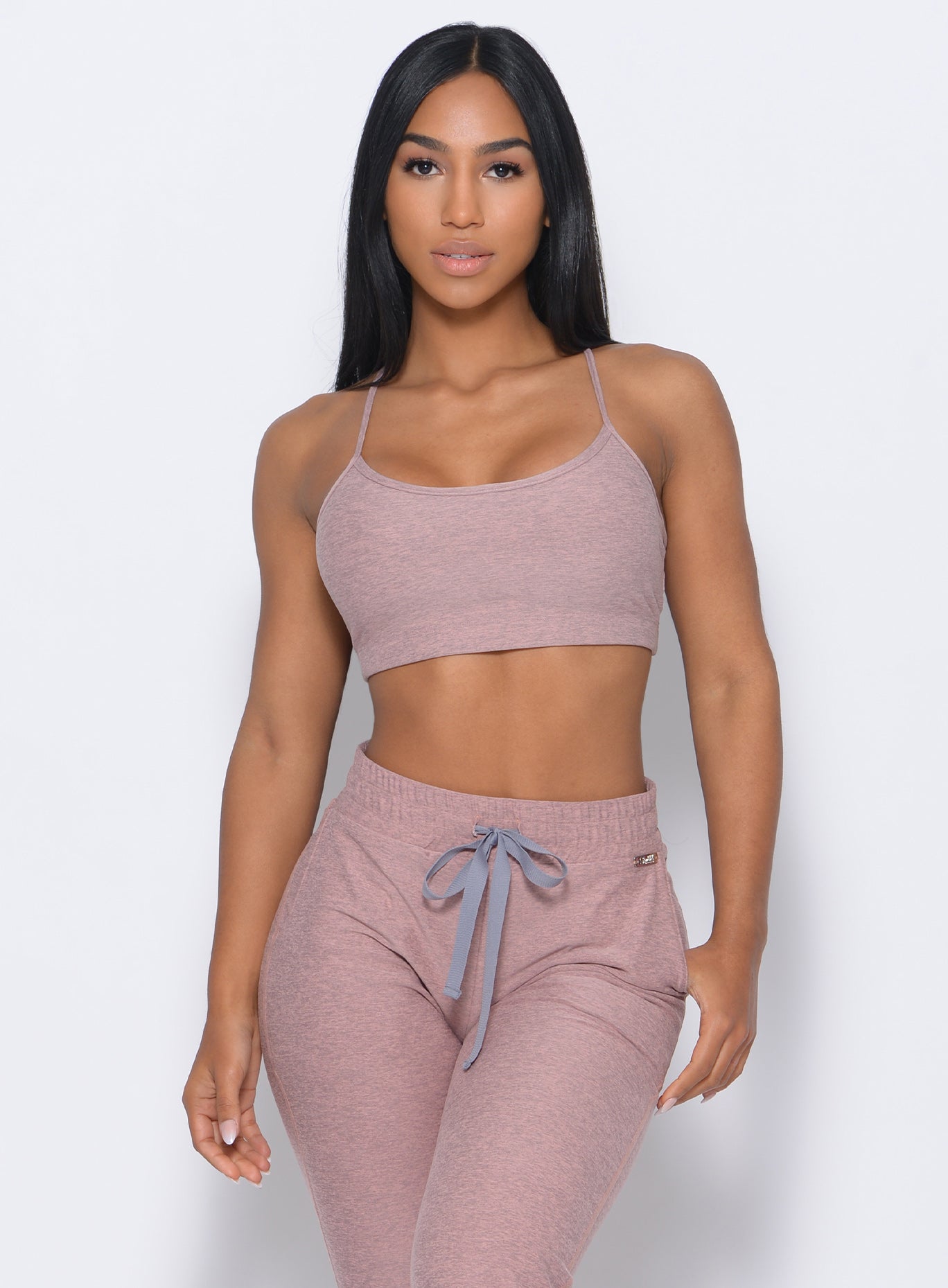 Front profile view of the model in our relax sports bra in sand dune color and a matching joggers