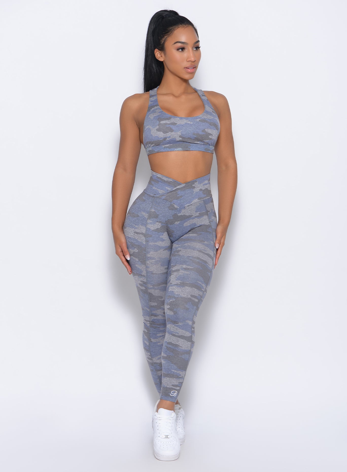 Front profile view of the model in our Brazilian contour leggings in silver camo color and a matching bra  