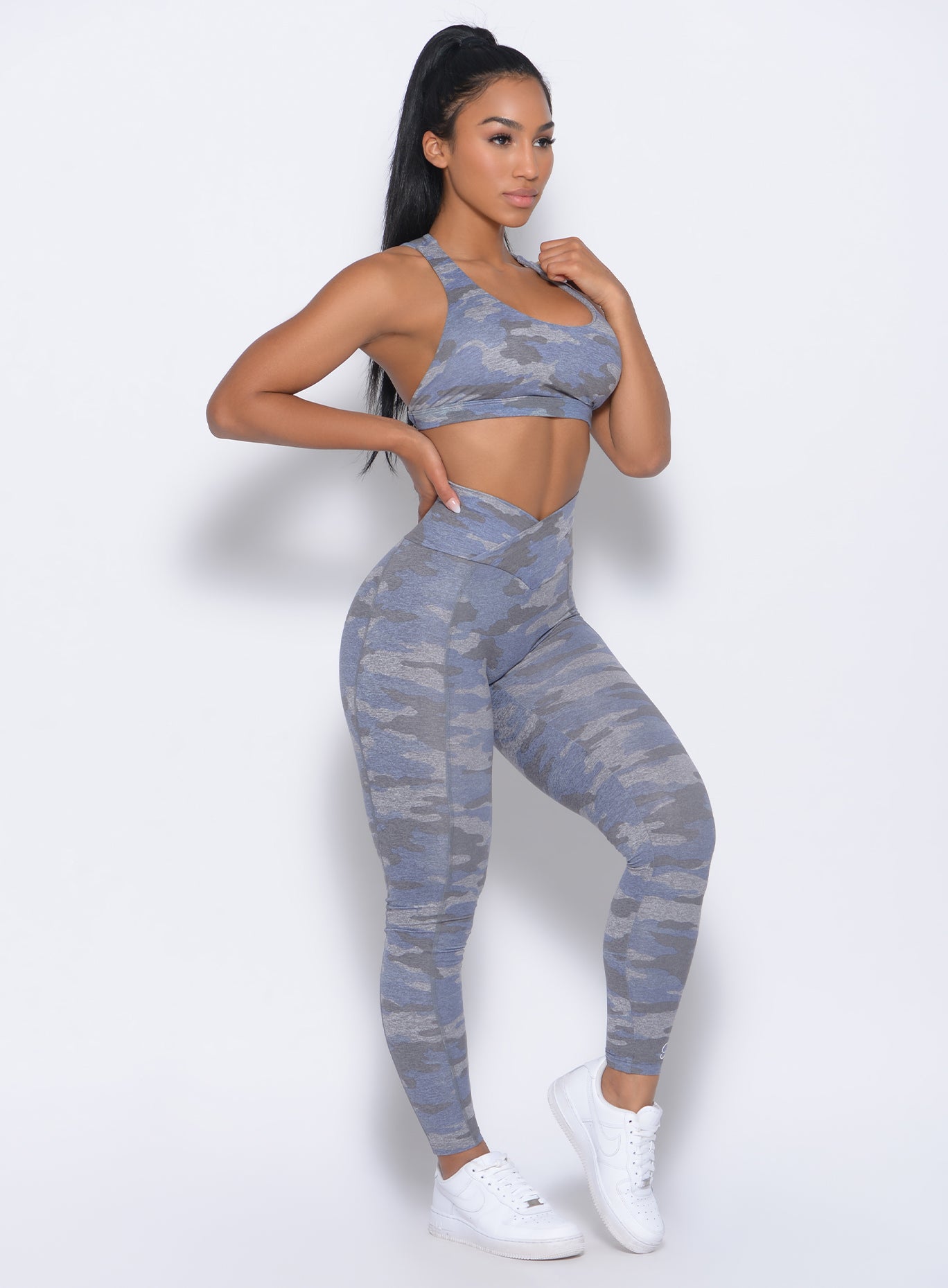 Right side view of the model wearing our brazilian contour leggings in silver camo and a matching bra 