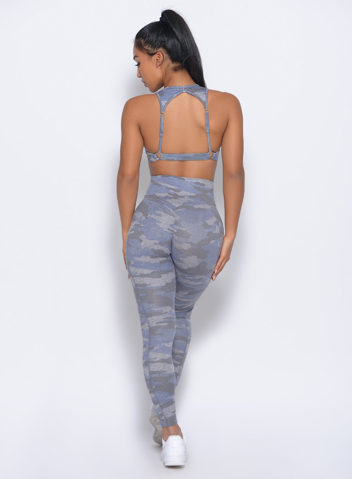 Back view of the model in our Brazilian contour leggings in silver camo color and a matching bra