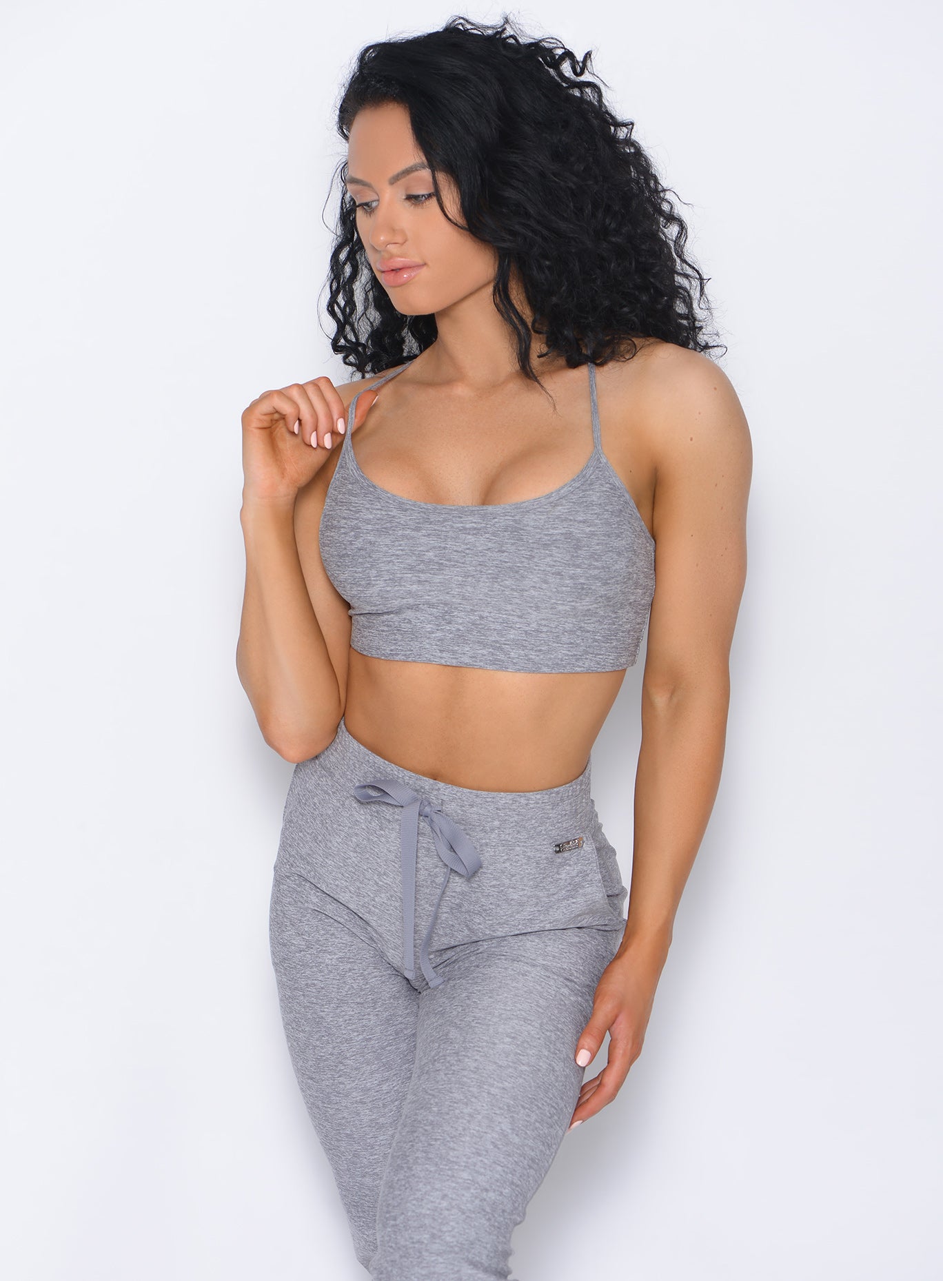 Front profile view of the model in our Relax Sports Bra in cloud color and a matching joggers