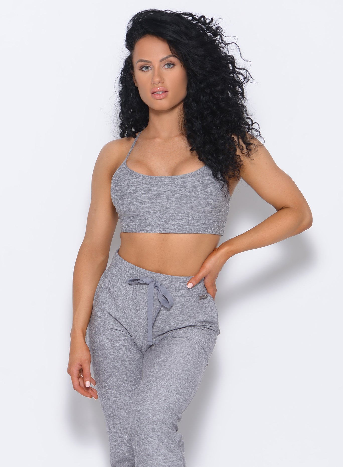 Front profile view of the model wearing our Relax Sports Bra in cloud color and a matching joggers