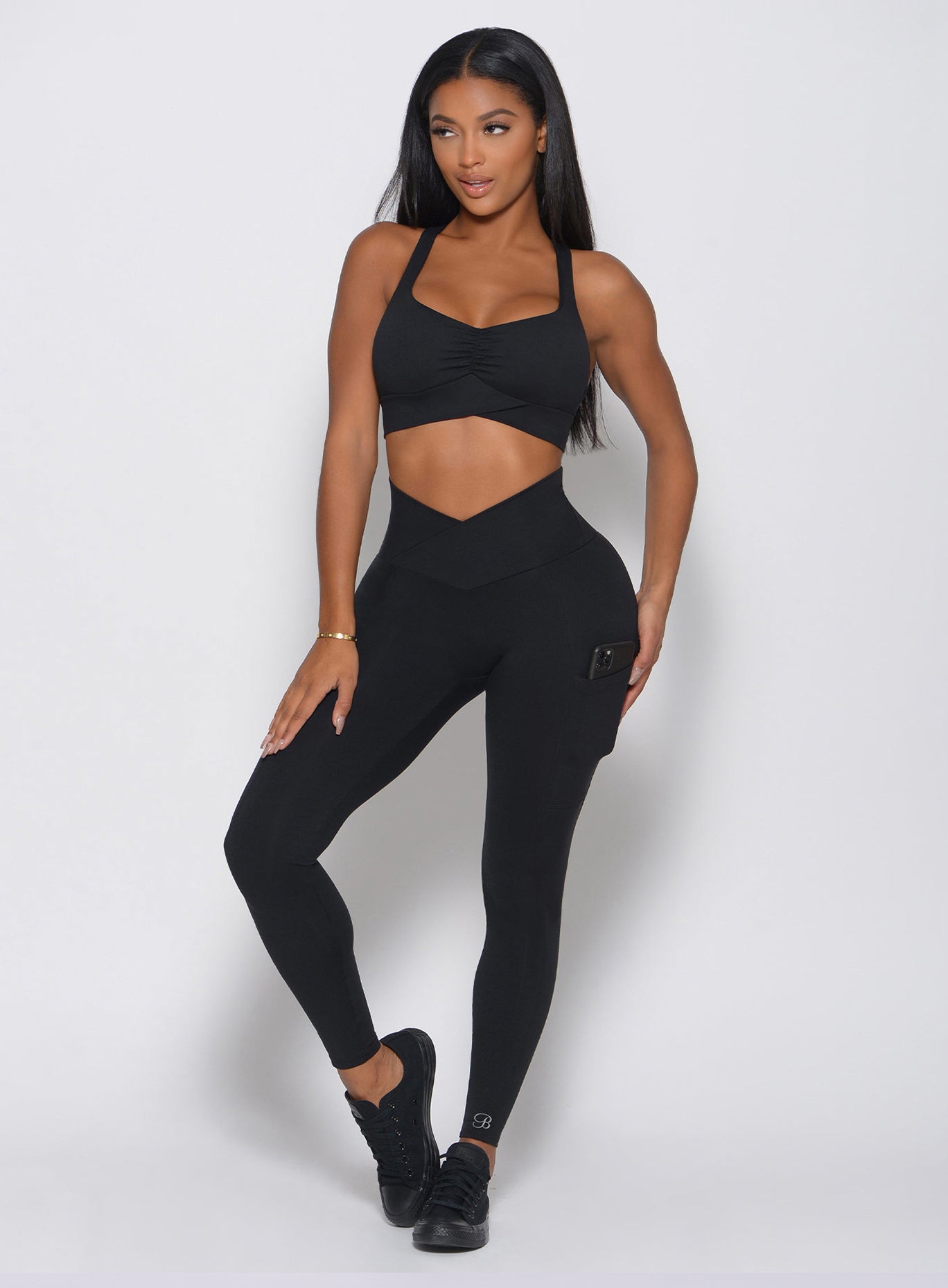 Black high-waisted Contour Leggings with sculpting seams and a figure-hugging gym fit.