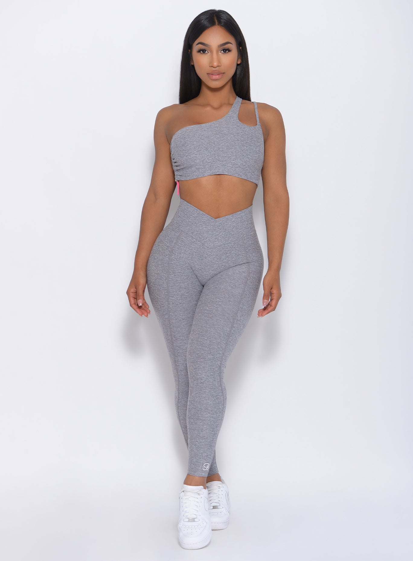 Front profile view of the model in our Brazilian Contour Legging in cloud color and a matching bra 