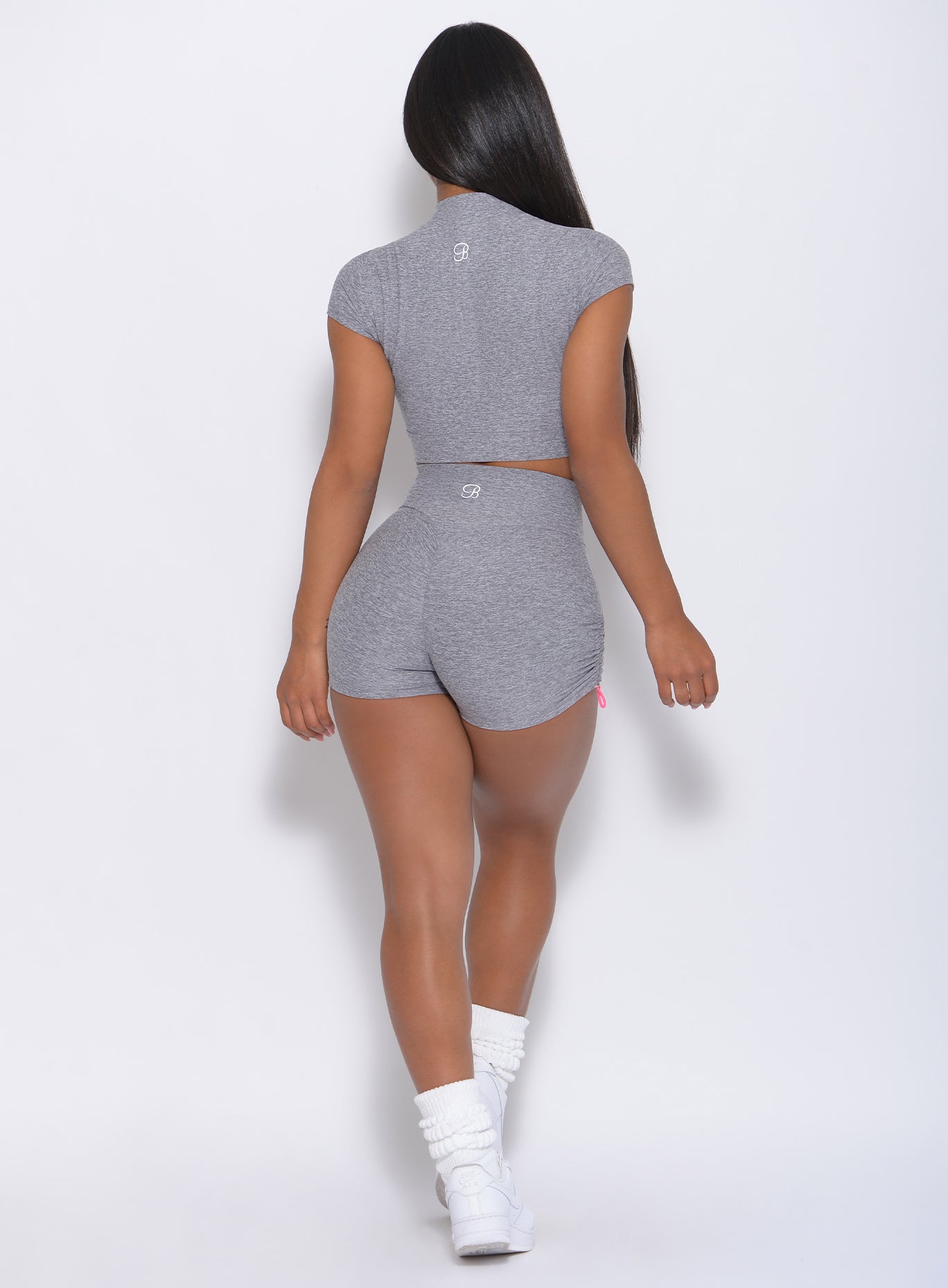 Back view of the model wearing our contour shorts in cloud color and a matching top