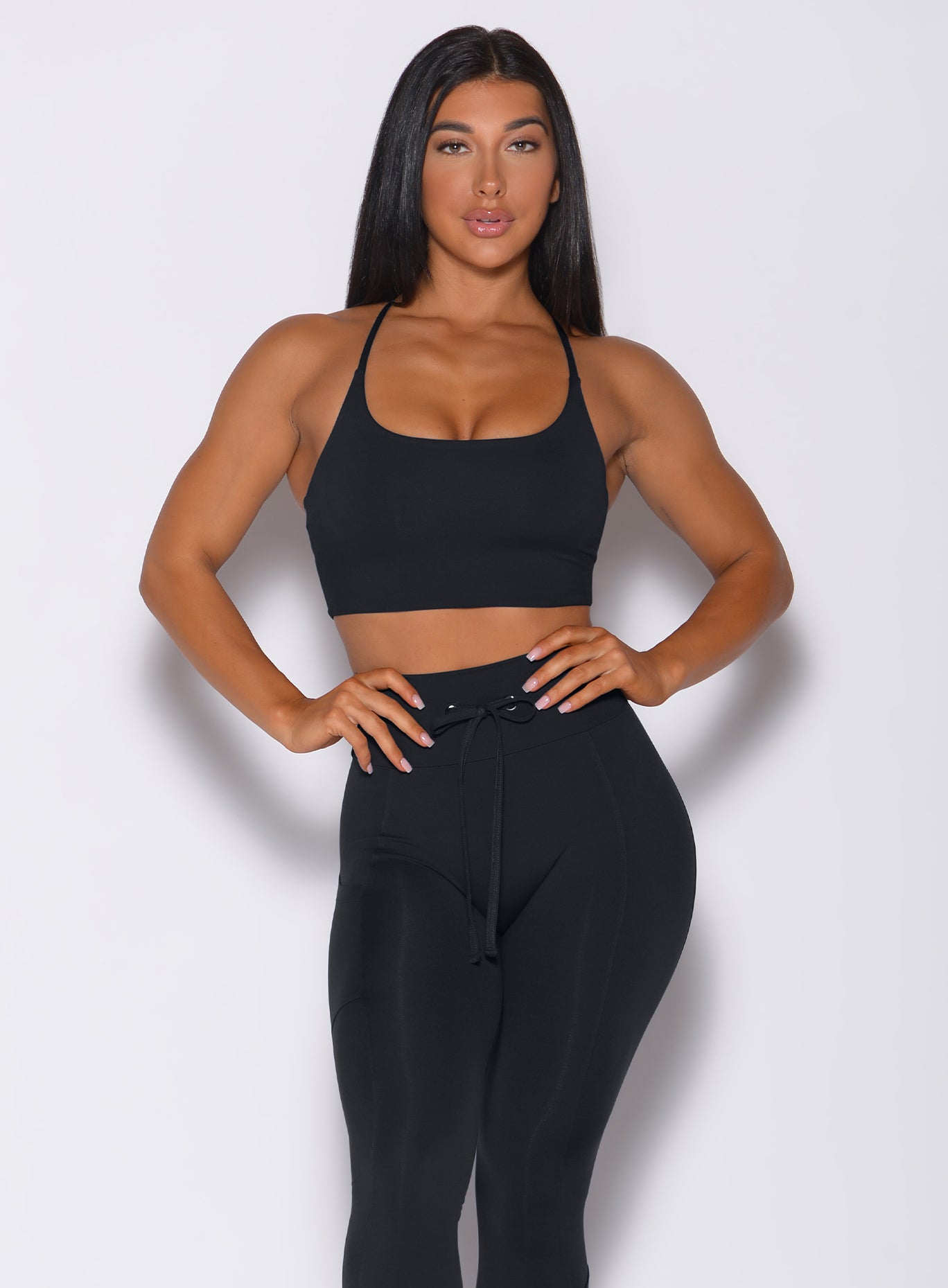 Model facing forward wearing our black Cross Fit Sports Bra and a matching leggings