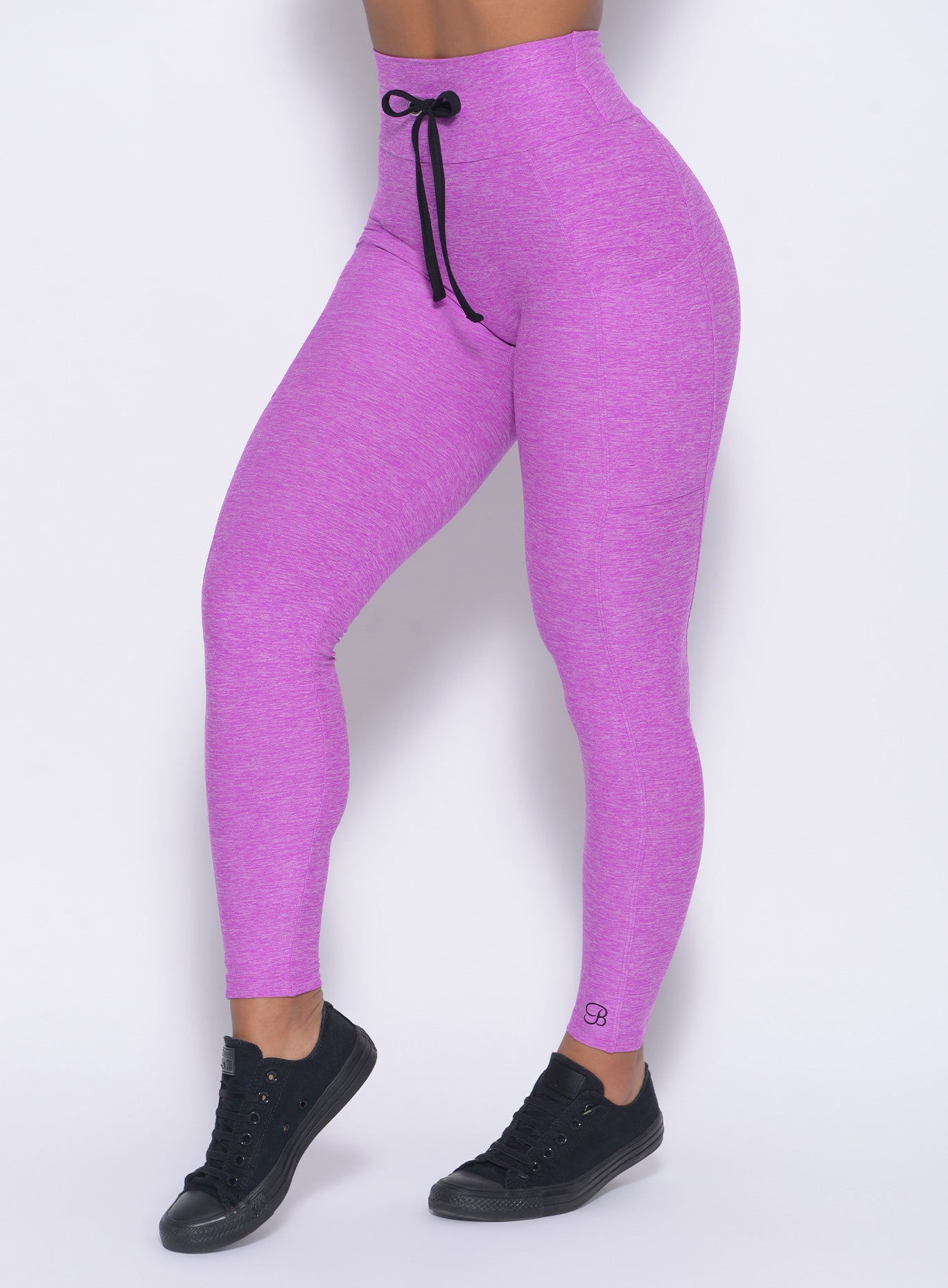 Zoomed in left side of our thrive leggings in purple color 