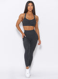 Front view  of the model wearing our curves high waist leggings in charcoal color and a matching bra