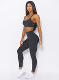 Left view of the model wearing our curves high waist leggings in charcoal color