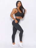 Right side view of the model wearing our curves high waist leggings in charcoal color and a matching bra