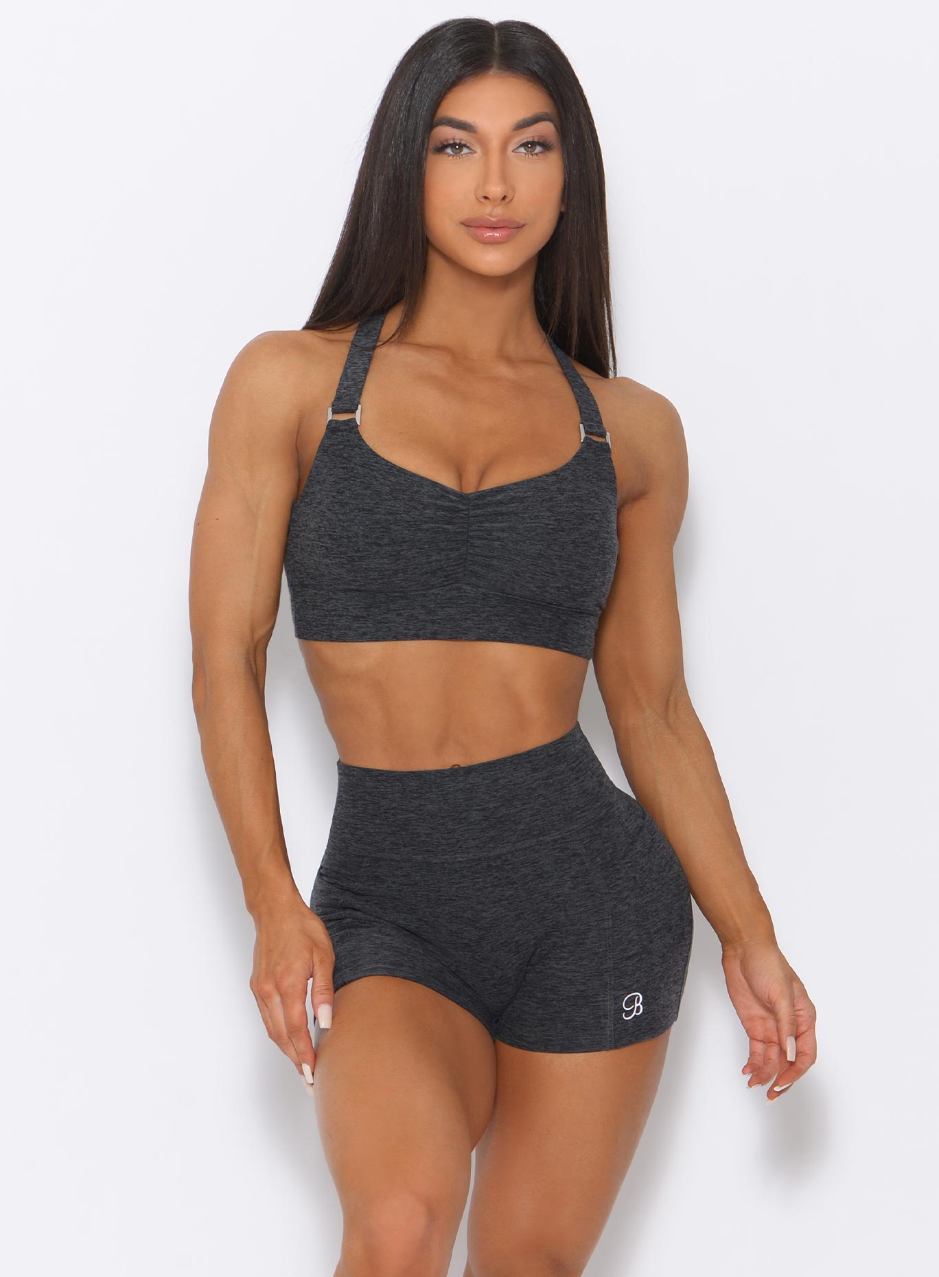 Front view of the model wearing our perfection sports bra in charcoal color and a matching shorts