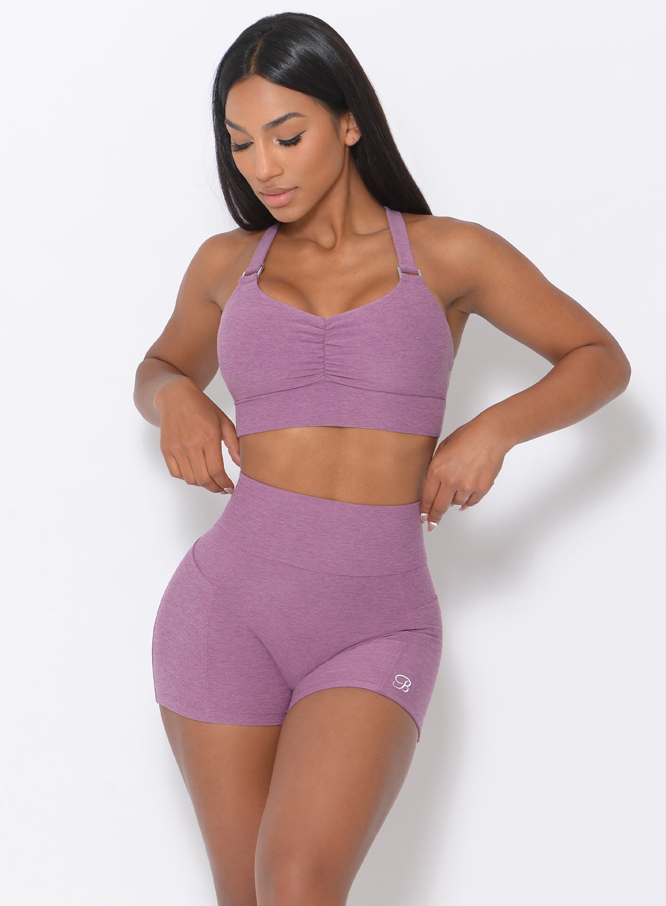 Front view of the model wearing our perfection sports bra in lavender and a matching shorts 