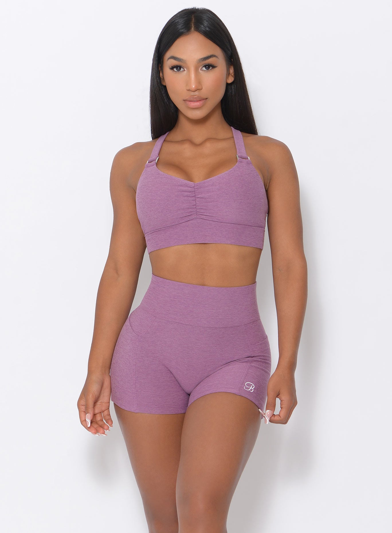 Model facing forward wearing our perfection sports bra in lavender and a matching shorts