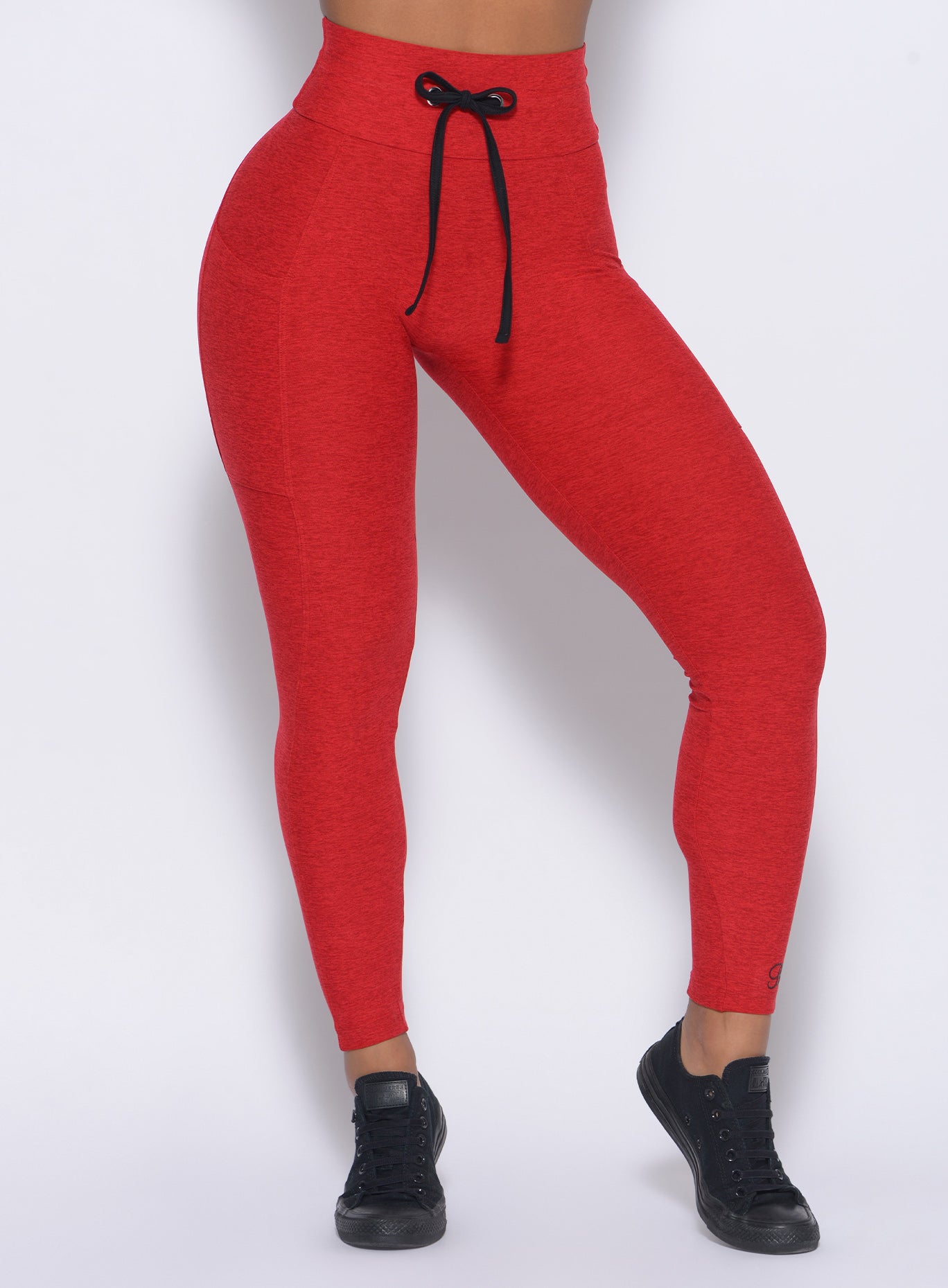 Zoomed in front view of our thrive leggings in sunset red 