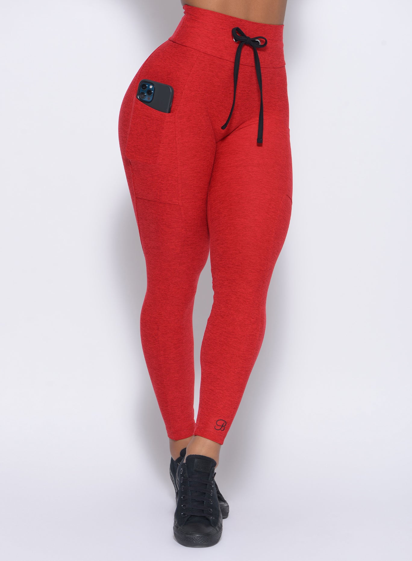 Front view of our thrive leggings in sunset red color 