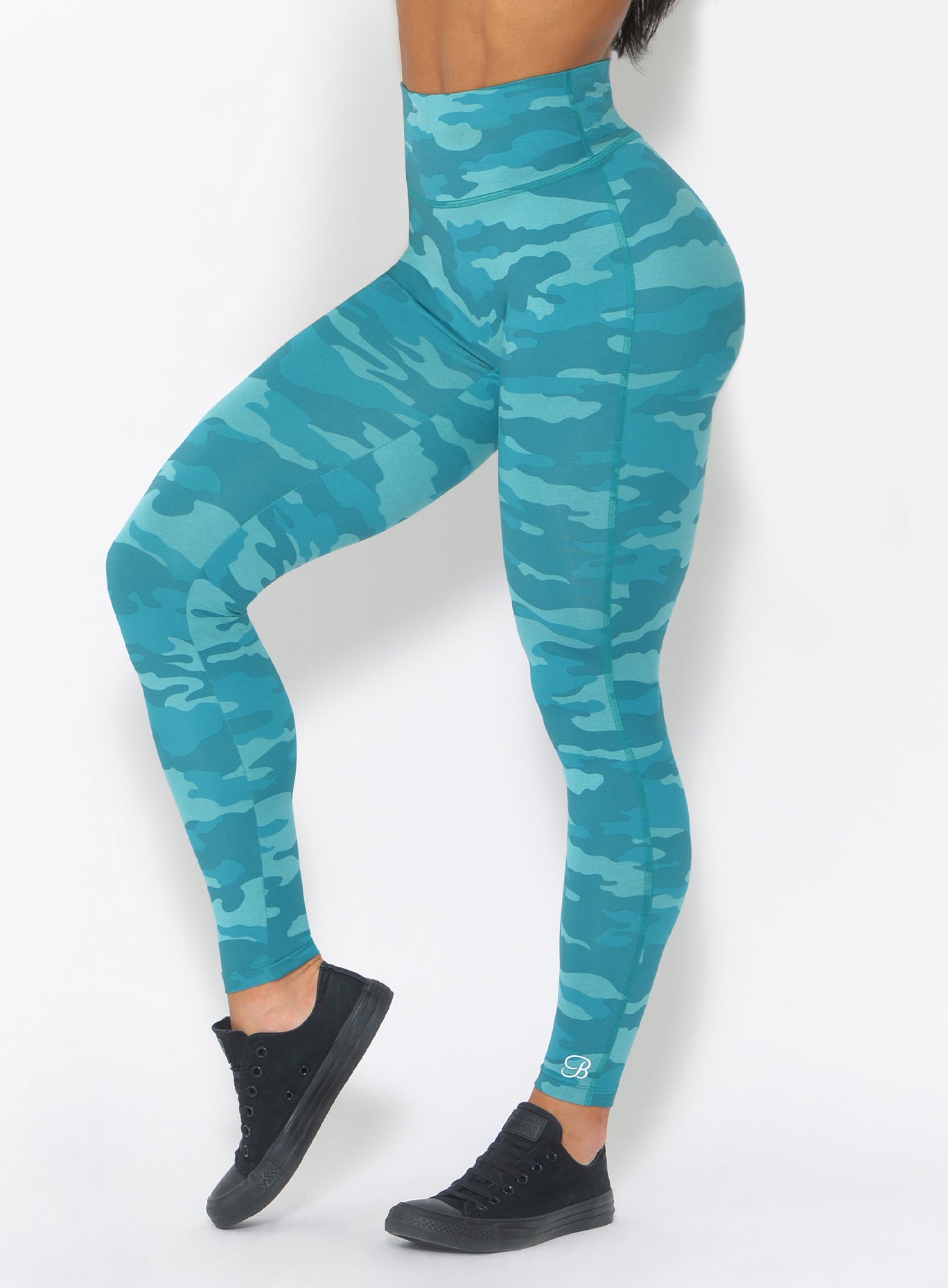 Zoomed in front view of the fit camo leggings in teal color