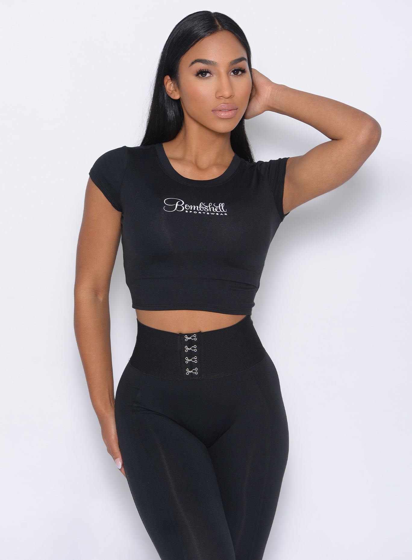 Model facing forward in our black fit fam tee and a matching leggings