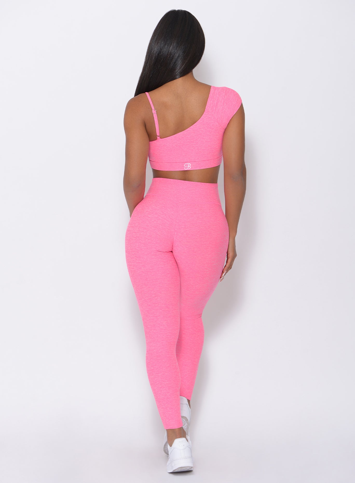 Back view of the model wearing our Adore Sports Bra in pink and a matching leggings