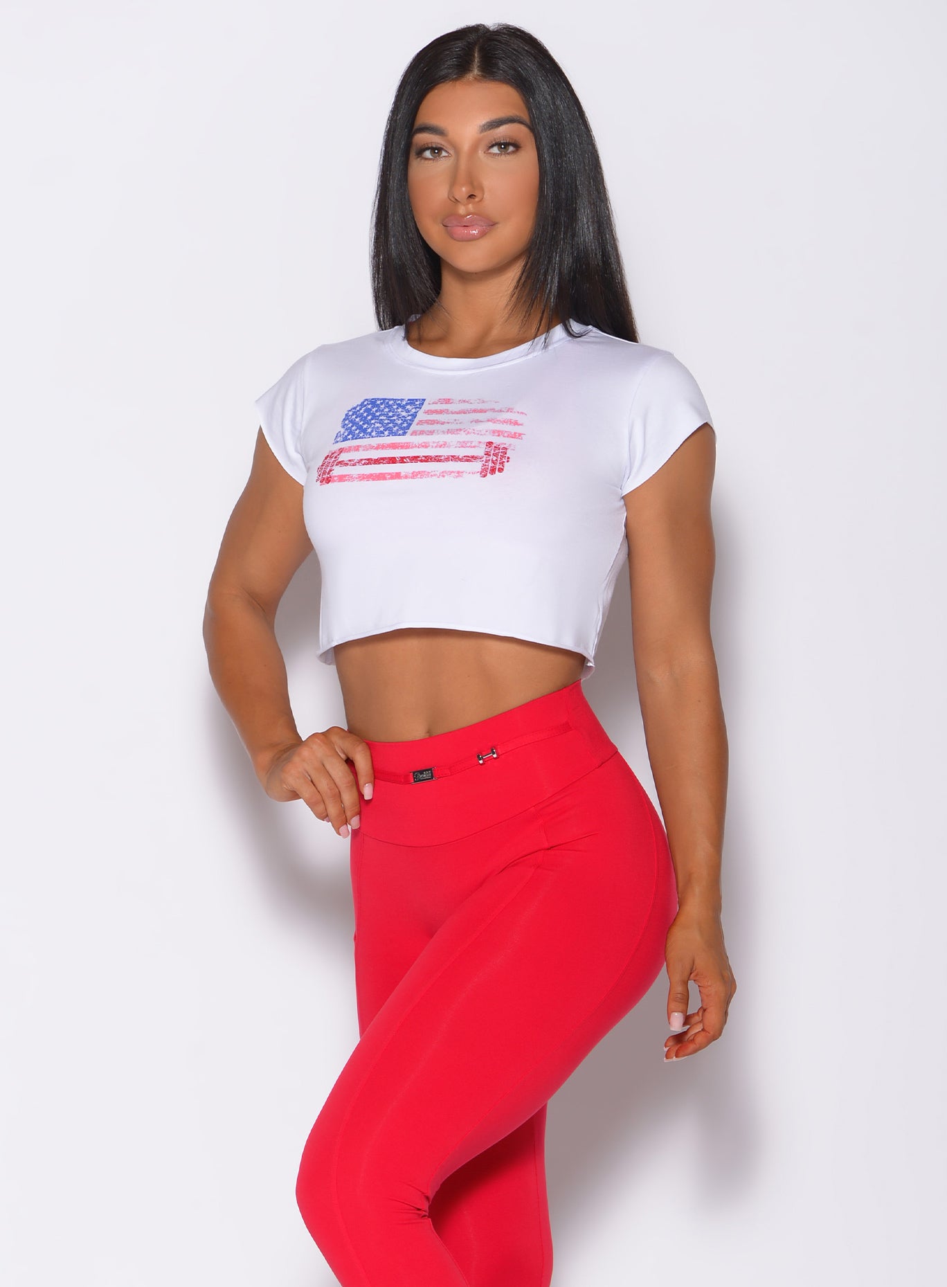 Zoomed in front profile view of a model in our white USA barbell leggings and a red high waist leggings 